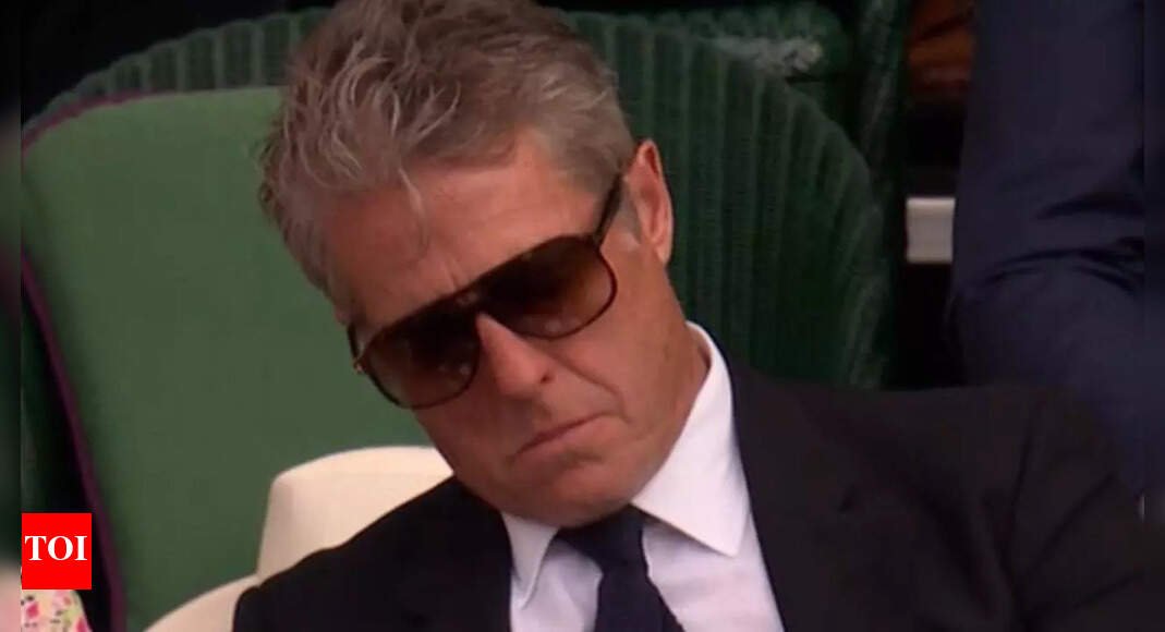 hugh-grant-goes-viral-after-falling-asleep-behind-queen-camilla-during-novak-djokovic-match-at-wimbledon-2025