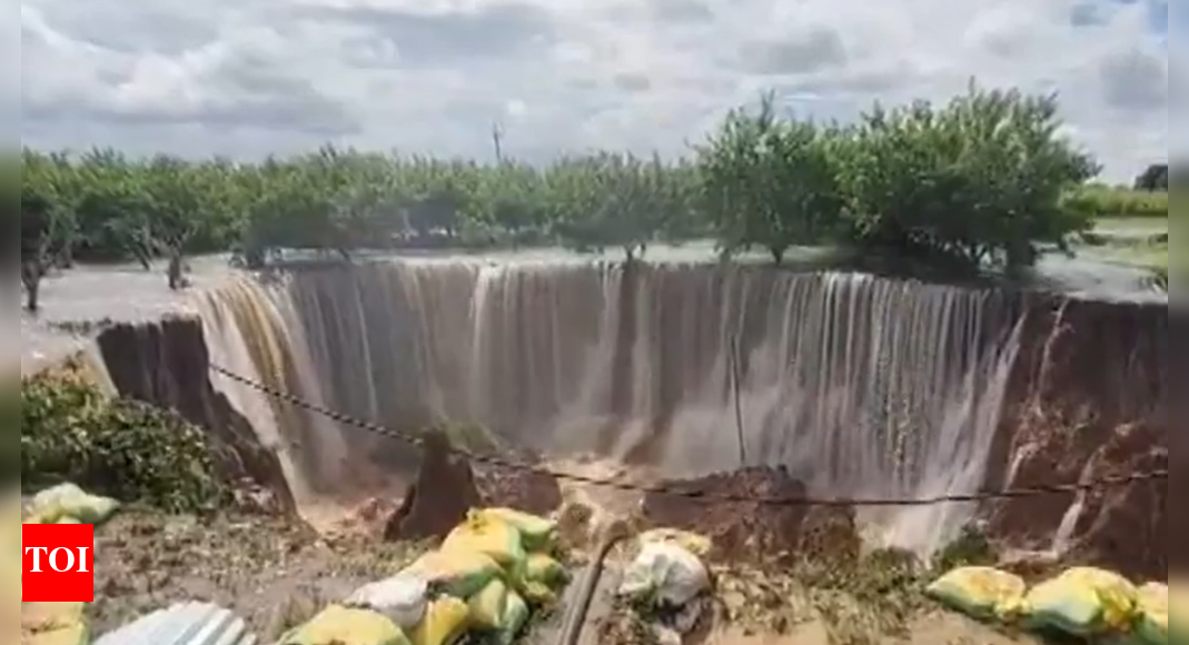 rajasthan-rain-havoc:-dam-overflow-triggers-huge-crater-in-sawai-madhopur;-villages-submerged,-roads-washed-out,-people-stuck-on-rooftops